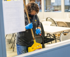 5 Star Janitorial employee weeping the floor