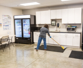 5 Star Janitorial employee sweeps the floor
