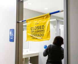 5 Star Janitorial employee cleans a bathroom