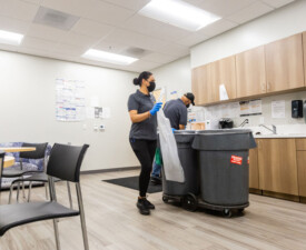 5 Star Janitorial employee changes a trash bag