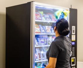 5 Star Janitorial employee wipes down a vending machine